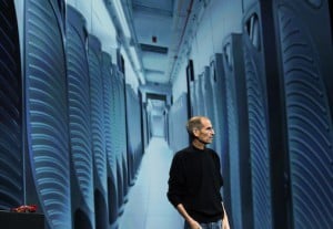 Steve Jobs is pictured with an image of server farm in Maiden